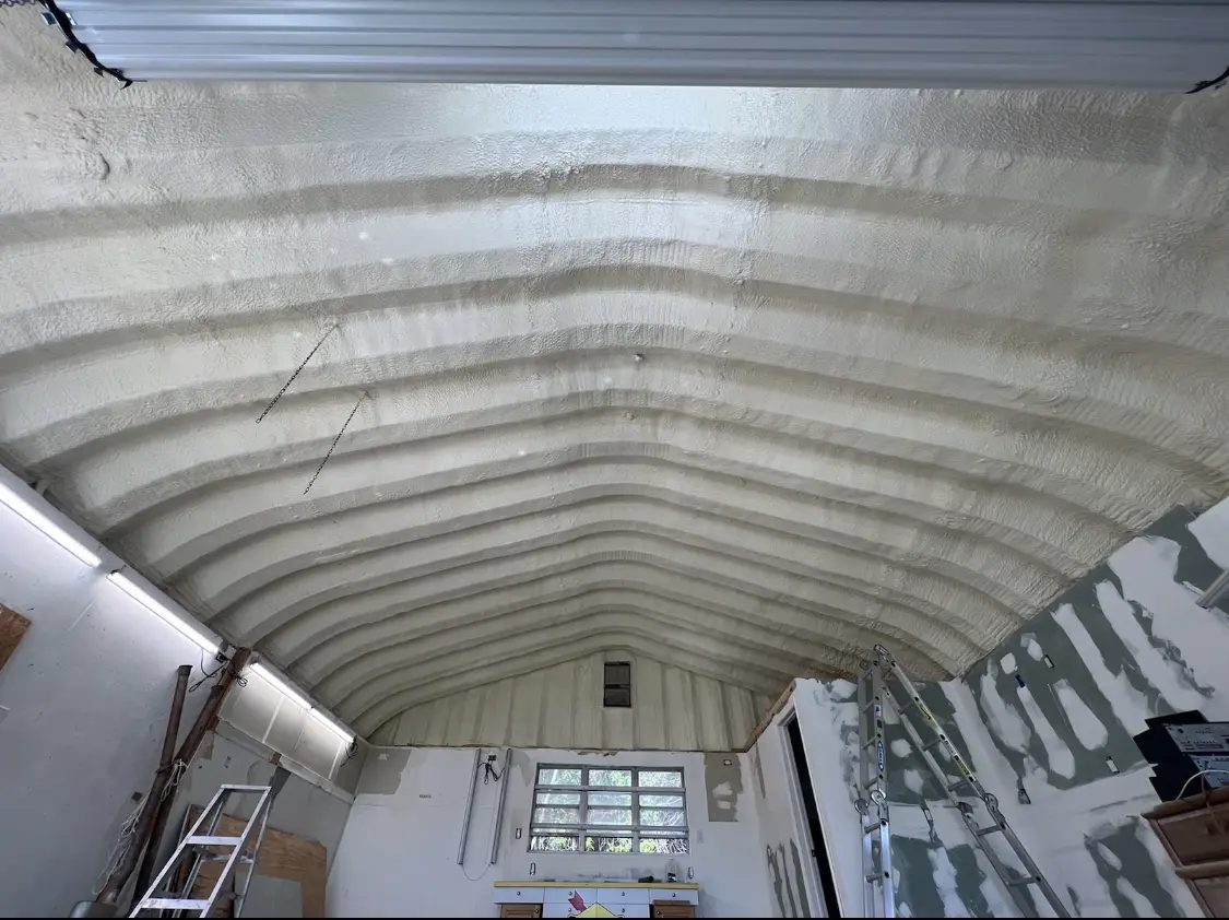 Spray polyurethane foam applied to the underside of a metal roof deck in Carmel
